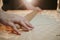 Closeup shot of a person using a rolling pin to prepare cookie dough