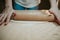 Closeup shot of a person using a rolling pin to prepare cookie dough