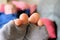 Closeup shot of a person wearing a torn gray socks with a blurred background