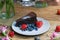 Closeup shot of a piece of brownie cake with blueberries and strawberries