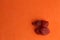 Closeup shot of a  piece of dried strawberries fruit isolated on an orange  background