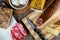 Closeup shot of a piece of parmesan cheese Ventricina sausage and bread on a cutting board