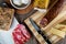 Closeup shot of a piece of parmesan cheese Ventricina sausage and bread on a cutting board