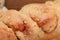 Closeup shot of a piece of a roasted chicken nugget on a wooden surface