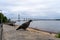 Closeup shot of a pigeon perched on a concrete seawall in Rosario, Argentina