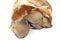 Closeup shot of a pile of edible mushrooms on a paper bag isolated on a white background