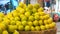 Closeup shot of a pile of lemons and limes at a market