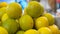 Closeup shot of a pile of lemons and limes at a market