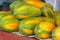 Closeup shot of a pile of papayas at a market