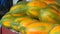 Closeup shot of a pile of papayas at a market