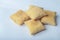 Closeup shot of a pile of square puff biscuits on a white surface