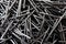 Closeup shot of a pile of steel nails on a black surface