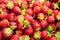 Closeup shot of a pile of strawberries freshly harvested from a farm