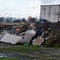 Closeup shot of a pile of trash and dirt and discarded furniture on an abandoned lot