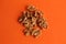 Closeup shot of a pile of walnuts isolated on an orange background