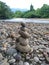 Closeup shot of piled-up rocks arranged alongside the river