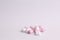 Closeup shot of pink and white mini marshmallows on a white background