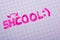 Closeup shot of a pink written text  Shcool with a reverse sign on paper with a smiley face