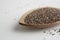 Closeup shot of a plate filled with quinoa seeds on a white surface