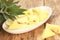 Closeup shot of a plate of juicy pineapple pieces on a wooden table