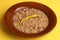 Closeup shot of a plate of red beans with chili pepper, typical Spanish dish