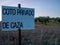 Closeup shot of a poster for a private hunting reservation in an olive grove under the blue sky