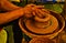 Closeup shot of potter hands crafting a clay pot