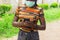 Closeup shot of pretty Afro-American female with mask standing with phone in her hands