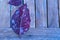 Closeup shot of a purplish-red fall leaf on a tiled wooden floor