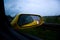Closeup shot of raindrops in a rear mirror of a yellow car