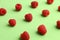 Closeup shot of raspberries arranged on a green table