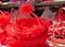 Closeup shot of a red basket with a laced rim and handle in a store