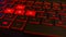 Closeup shot of a red computer keyboard with WASD highlighted