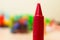 Closeup shot of a red crayon with a blurred background