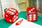 Closeup shot of red dices, playing cards and money on a poker table