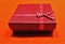 Closeup shot of a red gift box wrapped in a dotted tape