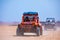 Closeup shot of red Jeeps driving in the desert in Hurghada, Egypt