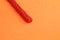 Closeup shot of a red liquorice candy isolated on an orange background