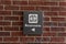 Closeup shot of a restroom sign on a brick wall