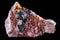 Closeup shot of Rhodochrosite mineral on an isolated black background