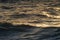 Closeup shot of ripples of the ocean in sunbeams