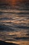 Closeup shot of ripples of the ocean in sunbeams at dusk