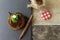 Closeup shot of a round caramel cake, a cinnamon stick and honey jar on a wooden surface