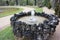 Closeup shot of a round fountain patterned with stone pieces in the gardens of Versailles.