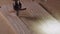 Closeup shot of a router carving wooden board and vacuuming the dust in a workshop