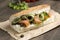 Closeup shot of a salmon sandwich with fresh vegetables in a baguette bread