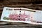 Closeup shot of a Saudi Arabia 100 SAR one hundred riyals cash banknote on a wooden surface
