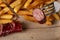 Closeup shot of a sausage piece on the fork with fries in the background