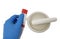 Closeup shot of a scientist\\\'s hand holding a tube of ointment with a mortar with pestle