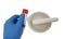 Closeup shot of a scientist\\\'s hand holding a tube of ointment with a mortar with pestle